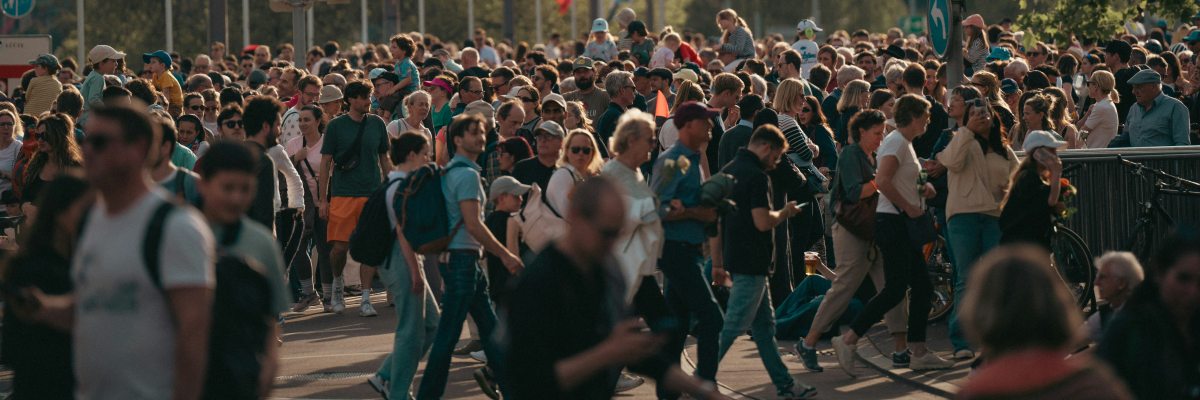 a crowd of people crossing the street